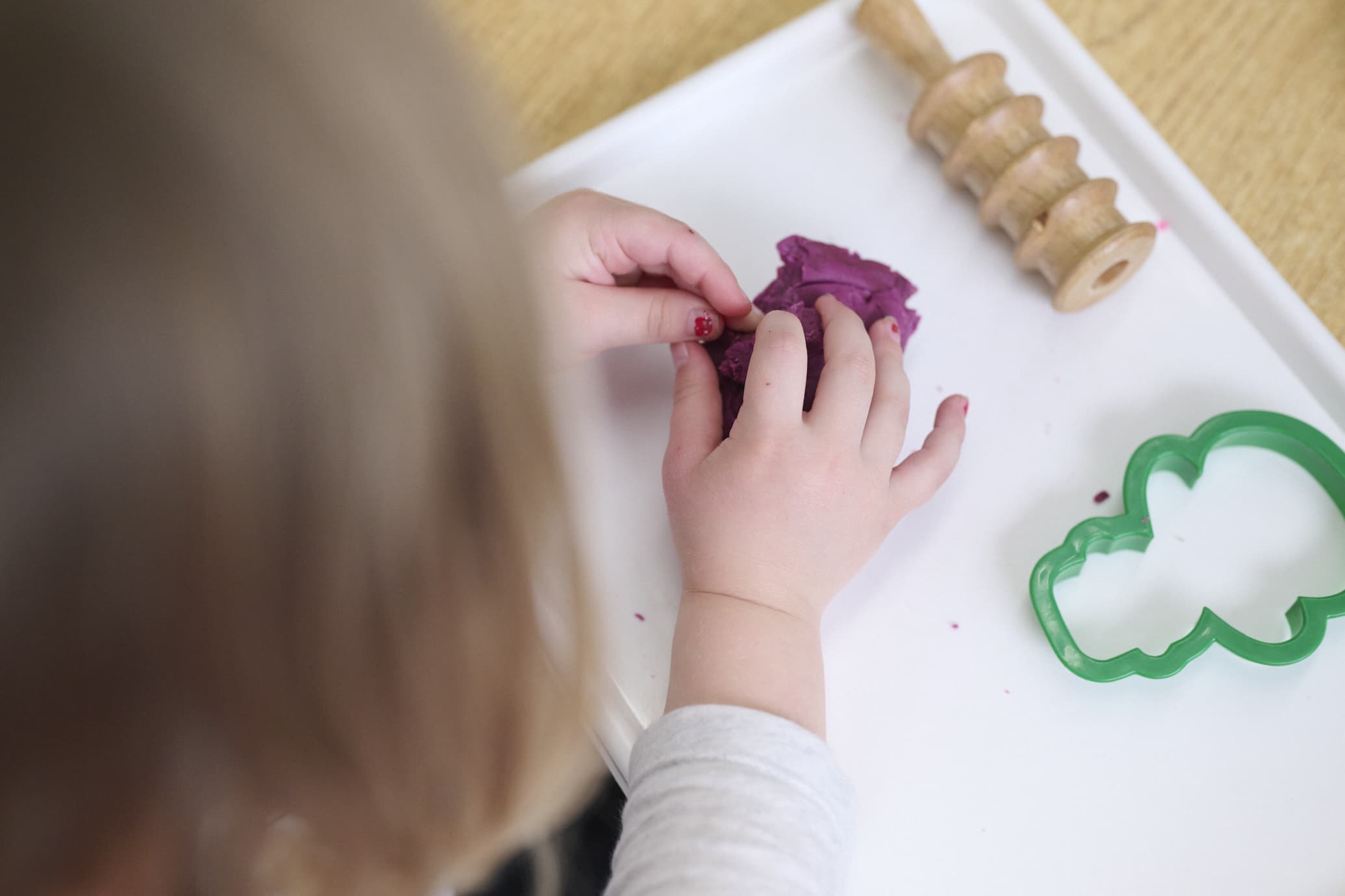 child playing with playdough