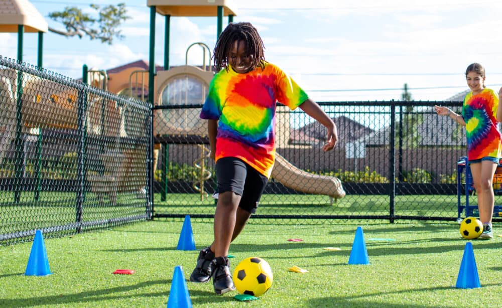 playing soccer during summer camp