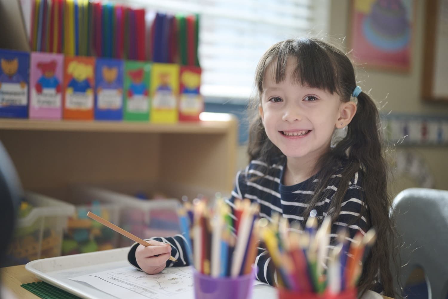 child writing and smiling